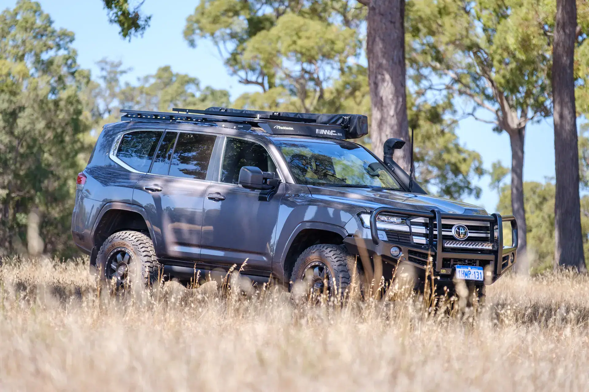 LandCruiser 300 staged touring build with bull bar, snorkel and roof platform in dry grassland