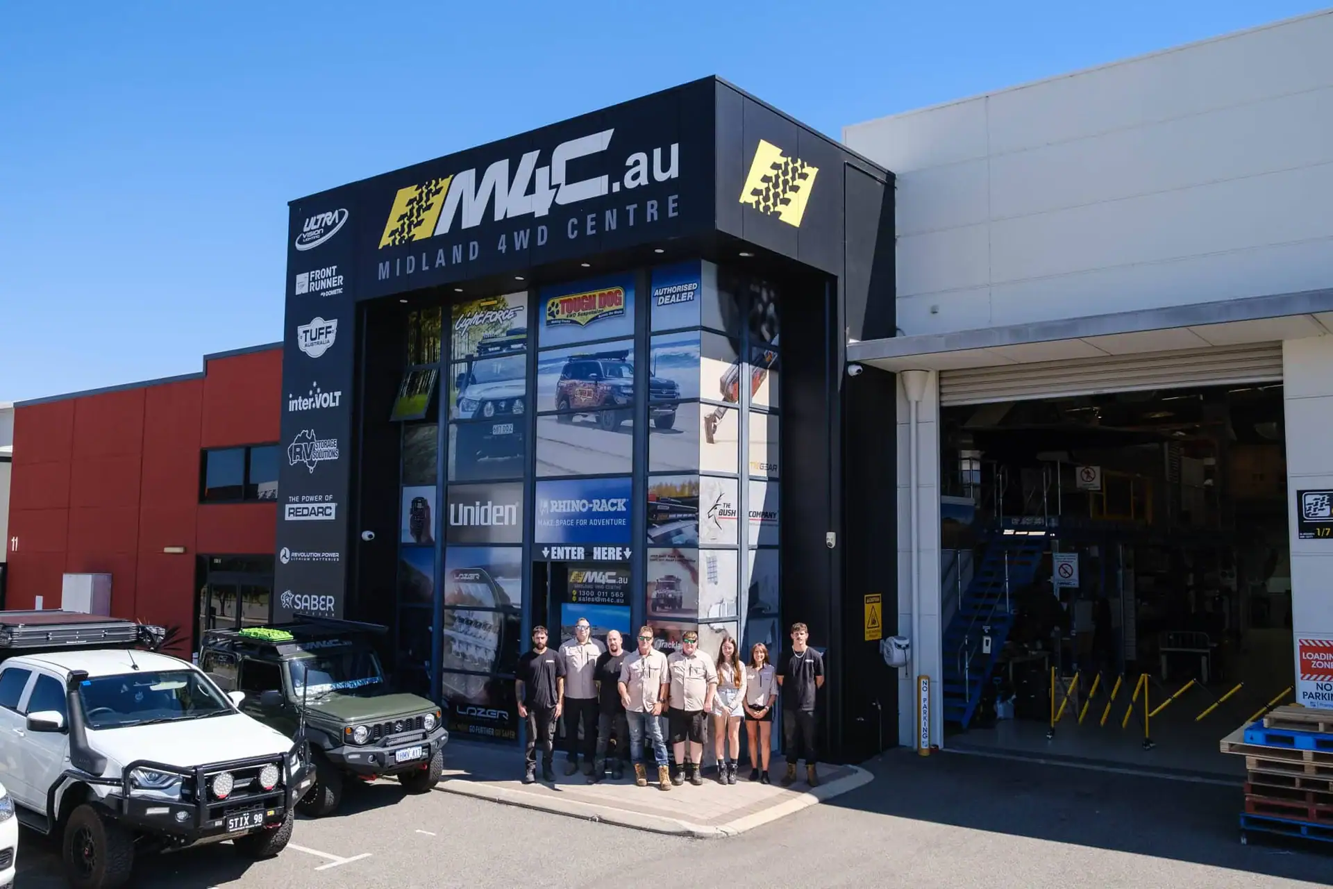 The M4C team outside the Canning Vale workshop with customer 4WDs